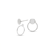 Load image into Gallery viewer, A pair of silver stud earrings featuring a flat circular disc on one earring and a textured oval frame with a matching disc on the other, shown on a plain white background.