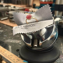 Load image into Gallery viewer, Lucy Ashton Jewellery Gold circle ring in jewellers vice with cremation ashes and red pearl setting
