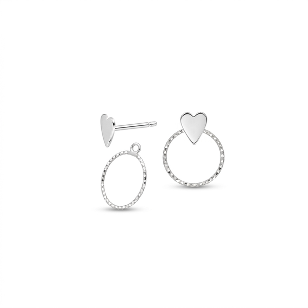 A pair of silver heart stud earrings on a plain white background, one showing a polished heart-shaped stud with a post, and the other showing a textured circular hoop with a small heart at the top.