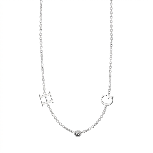 A delicate silver necklace featuring an 'H' initial pendant, a small polished bead, and a 'C' initial pendant on a fine cable chain, shown against a plain white background.